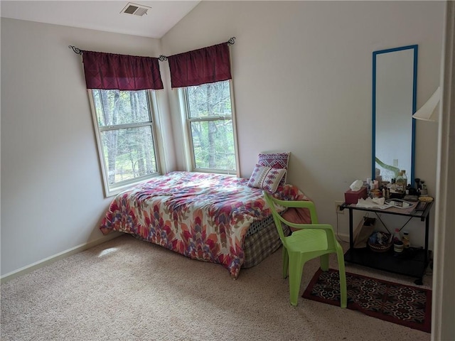 bedroom with carpet floors and vaulted ceiling