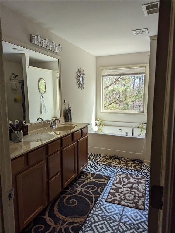 bathroom featuring vanity and a tub