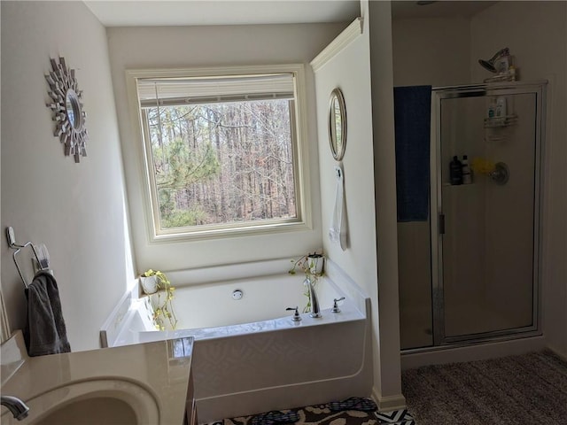 bathroom featuring plus walk in shower and vanity