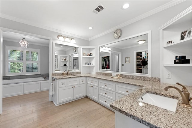 4250 Green Ridge Dr NE, Marietta, GA 30062 - bathroom featuring double vanity, a garden tub, wood finished floors, crown molding, and recessed lighting