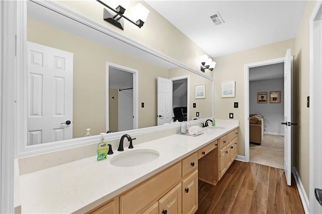 4250 Green Ridge Dr NE, Marietta, GA 30062 - bathroom featuring double vanity, wood finished floors, and connected bathroom