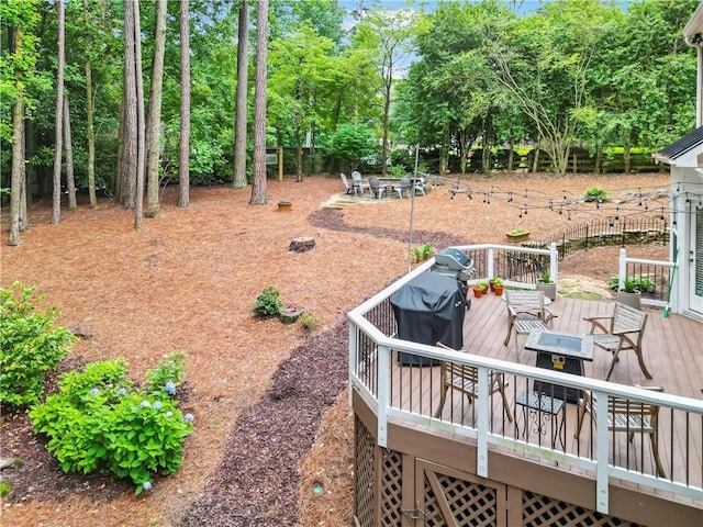 4250 Green Ridge Dr NE, Marietta, GA 30062 - view of yard with a wooden deck, outdoor dining area, and view of wooded area