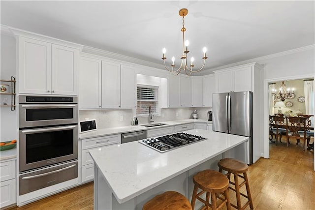 4250 Green Ridge Dr NE, Marietta, GA 30062 - kitchen with a chandelier, a warming drawer, stainless steel appliances, white cabinetry, and a kitchen breakfast bar