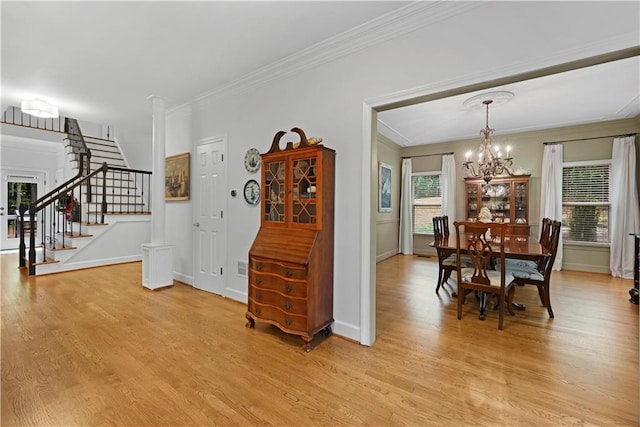 4250 Green Ridge Dr NE, Marietta, GA 30062 - dining space with a chandelier, crown molding, light wood finished floors, and stairs