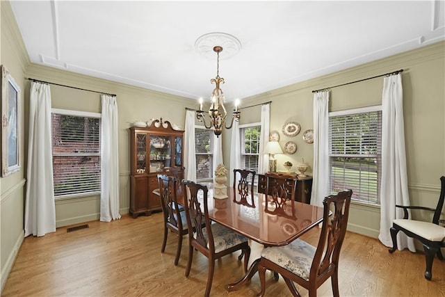 4250 Green Ridge Dr NE, Marietta, GA 30062 - dining space featuring a chandelier, light wood-style flooring, and crown molding
