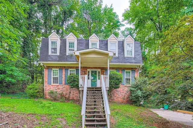 2867 Holly Oaks Dr, Marietta, GA 30062 - new england style home featuring brick siding, mansard roof, roof with shingles, and a front lawn