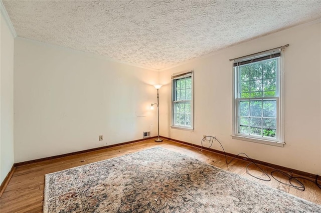 2867 Holly Oaks Dr, Marietta, GA 30062 - spare room with wood finished floors, ornamental molding, and a textured ceiling