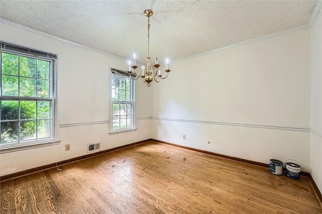 2867 Holly Oaks Dr, Marietta, GA 30062 - unfurnished room with ornamental molding, a chandelier, wood finished floors, and a textured ceiling