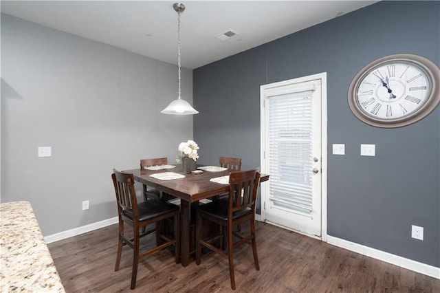 dining space with dark hardwood / wood-style flooring