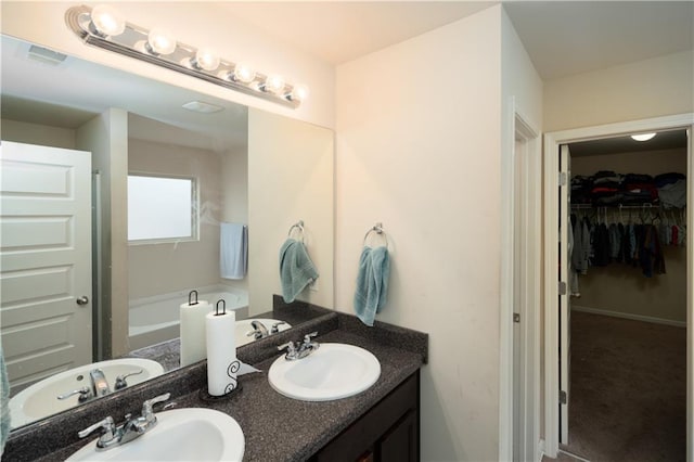 bathroom with vanity and a bathtub