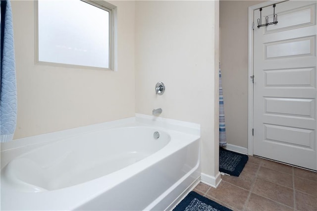 bathroom featuring tile patterned flooring and a bath