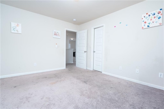 unfurnished bedroom with light colored carpet