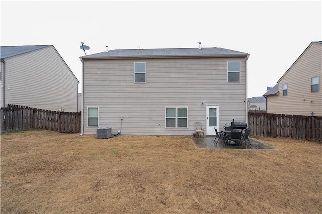 rear view of property featuring a patio, central air condition unit, and a lawn