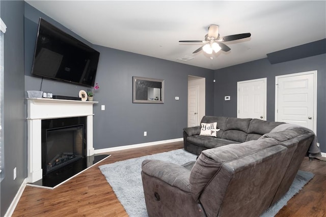 living room featuring hardwood / wood-style floors and ceiling fan