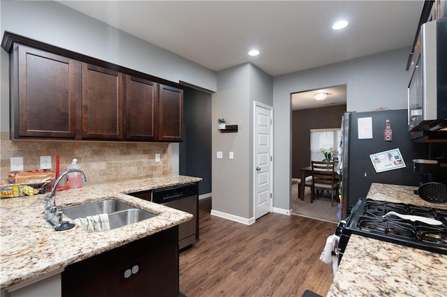 kitchen with dark wood-type flooring, dark brown cabinetry, sink, light stone counters, and stainless steel appliances