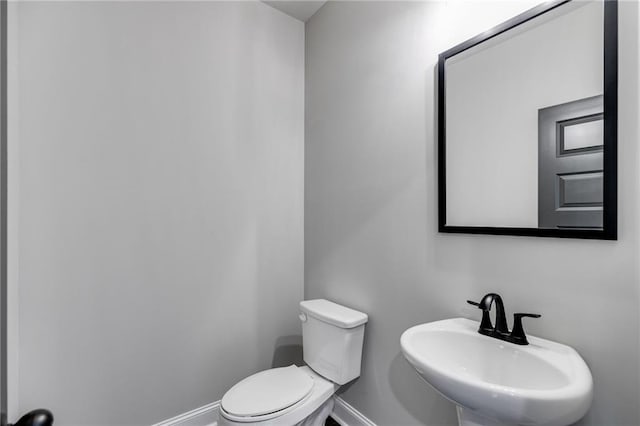 bathroom featuring toilet and sink