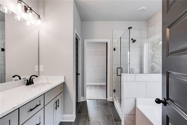 bathroom featuring tile patterned flooring, vanity, and shower with separate bathtub