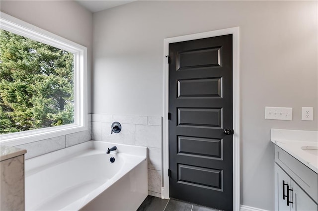 bathroom featuring vanity and a washtub