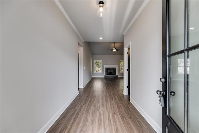 hallway with crown molding and hardwood / wood-style floors