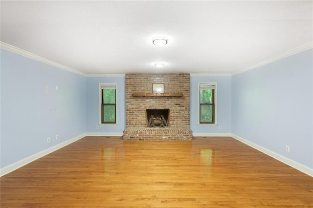 unfurnished living room with plenty of natural light, light wood-style flooring, and baseboards