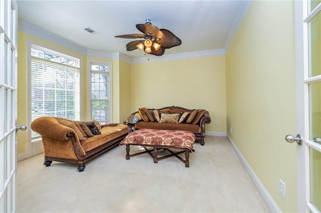 interior space featuring ceiling fan, ornamental molding, carpet, and plenty of natural light