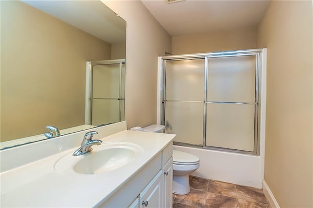 full bathroom with toilet, enclosed tub / shower combo, and vanity