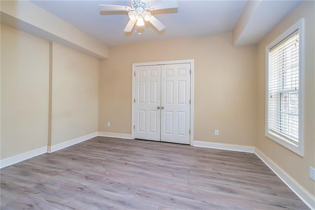 unfurnished bedroom with a closet, ceiling fan, and light hardwood / wood-style floors