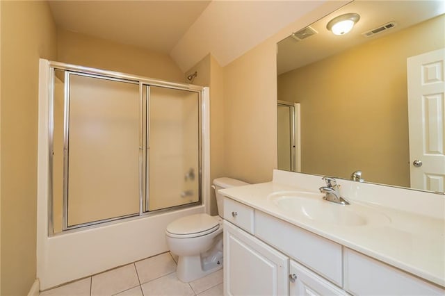 full bathroom with combined bath / shower with glass door, tile patterned flooring, vanity, and toilet