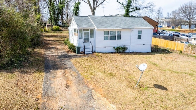 exterior space featuring crawl space, entry steps, a front yard, and fence