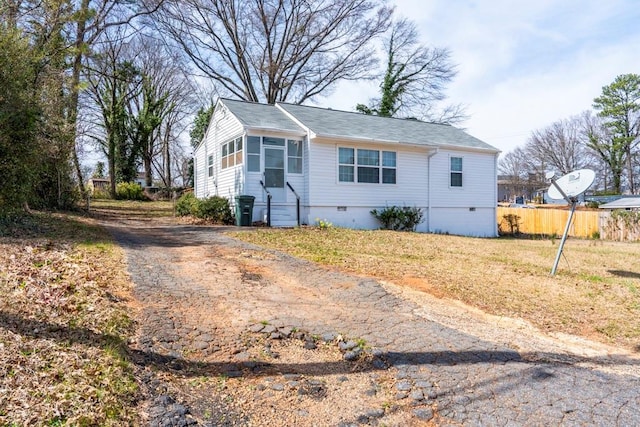 view of front of house featuring crawl space and fence