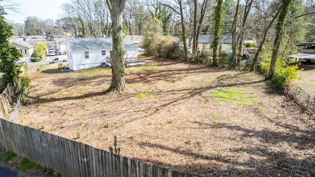 view of yard featuring a residential view and fence