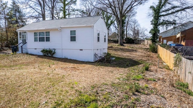 view of property exterior with crawl space and fence