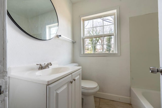 bathroom with tile patterned floors, baseboards, toilet, a bath, and vanity