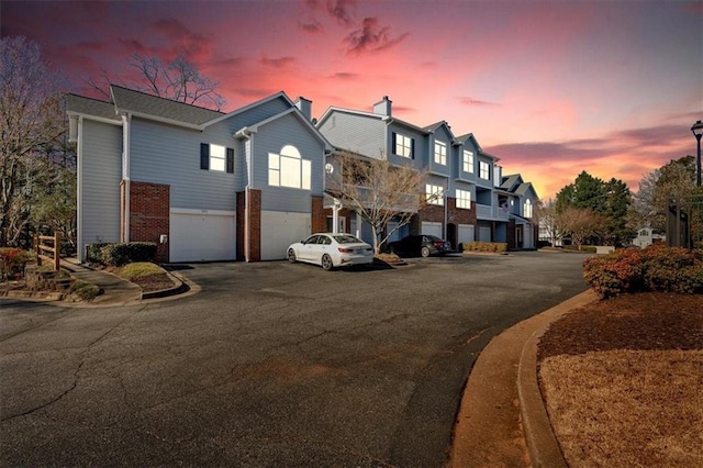 exterior space featuring street lights and curbs