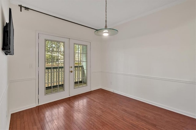 interior space featuring dark wood-style floors, baseboards, crown molding, and french doors