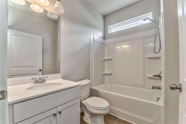 bathroom featuring toilet, vanity, and bathtub / shower combination
