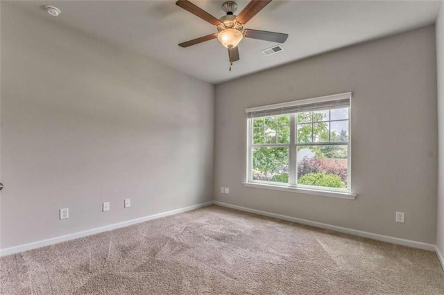 unfurnished room with baseboards, carpet, ceiling fan, and a smoke detector