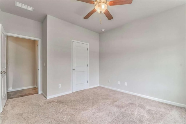 unfurnished bedroom featuring carpet flooring, baseboards, and ceiling fan