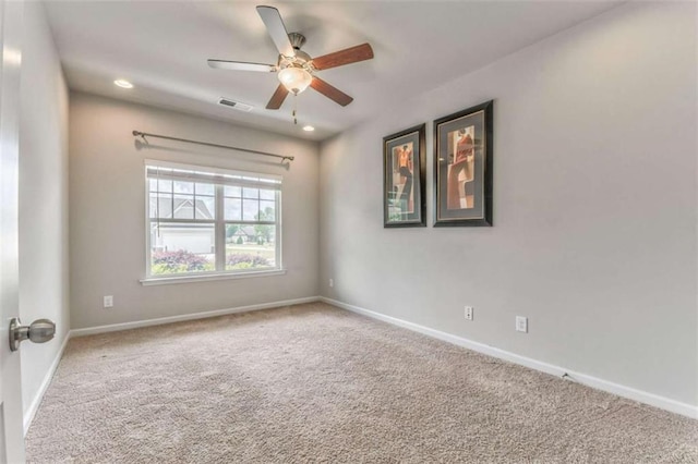 carpeted spare room with a ceiling fan, baseboards, and recessed lighting