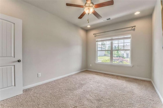 spare room featuring carpet flooring, baseboards, and recessed lighting