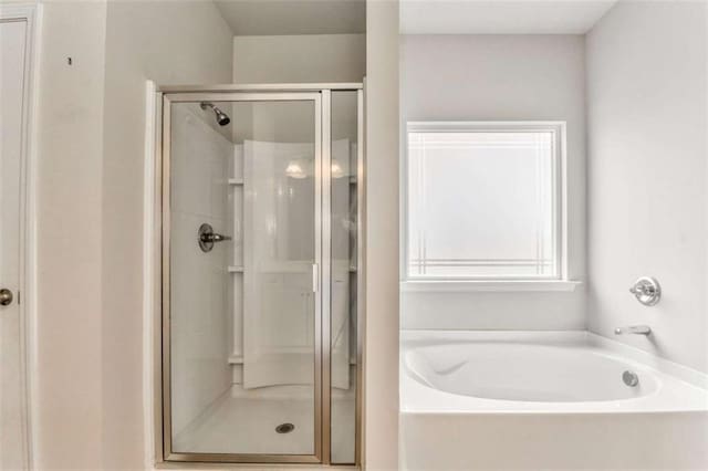 full bath featuring a shower stall and a bath