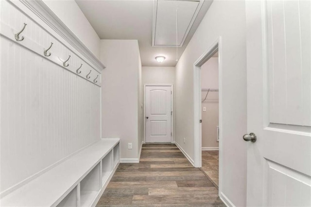 mudroom featuring attic access, wood finished floors, and baseboards