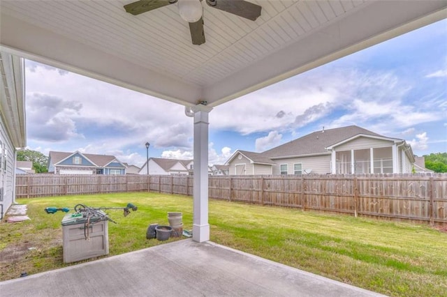 view of patio featuring a ceiling fan and a sunroom
