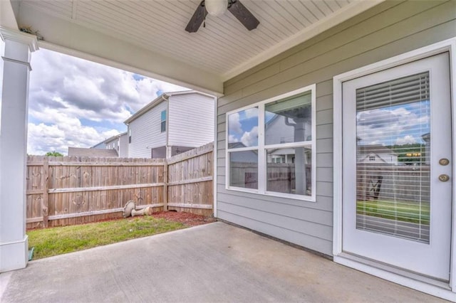 view of patio / terrace with ceiling fan and fence