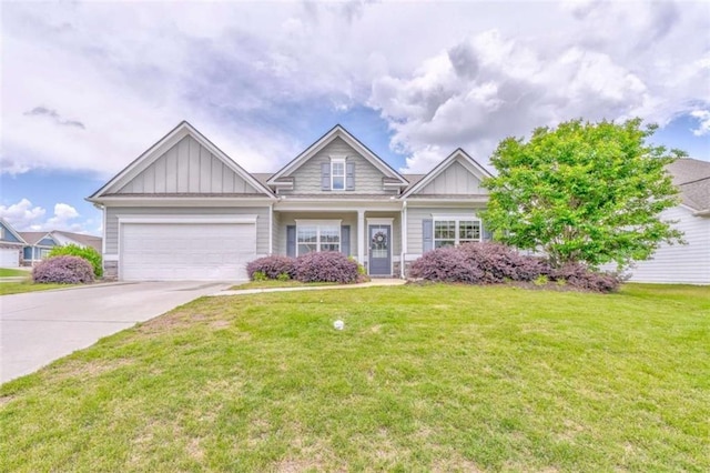 craftsman inspired home featuring board and batten siding, concrete driveway, an attached garage, and a front lawn