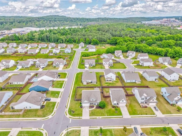aerial perspective of suburban area featuring a forest