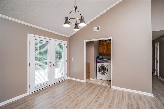 laundry area with cabinets, french doors, an inviting chandelier, independent washer and dryer, and light hardwood / wood-style floors