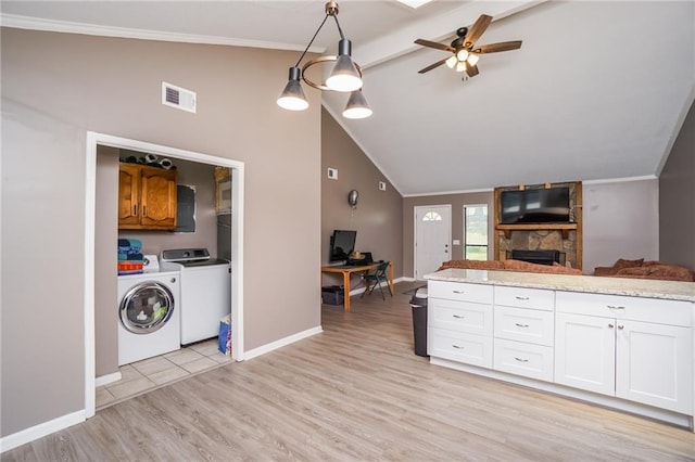 kitchen with white cabinets, lofted ceiling with beams, ceiling fan, decorative light fixtures, and washing machine and clothes dryer