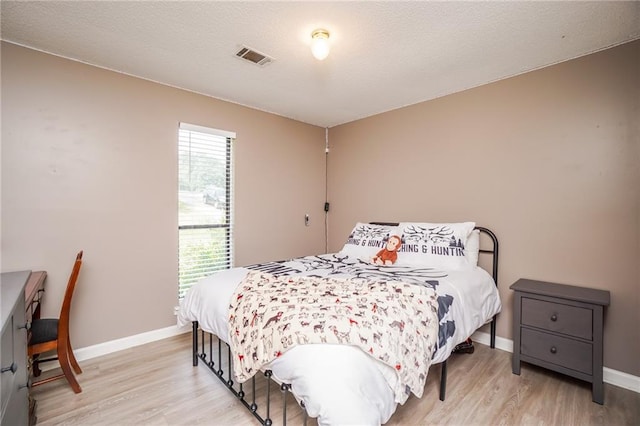 bedroom with light wood-type flooring