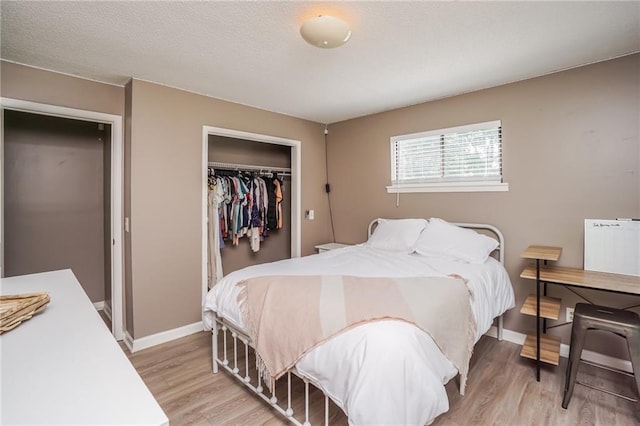 bedroom featuring a closet and light wood-type flooring